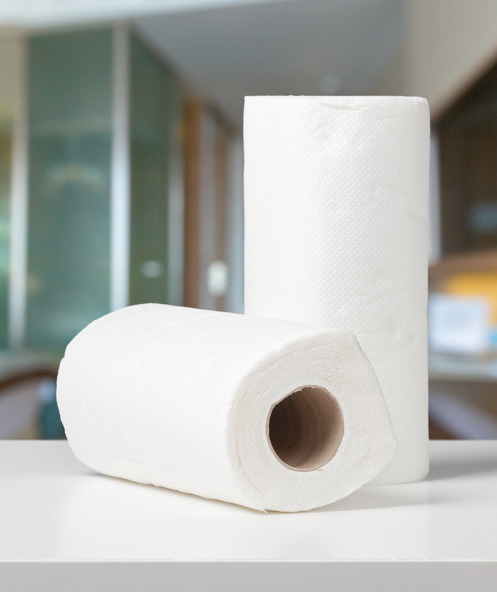 Soft paper towels on a white desk front view
